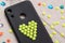 Black phone case decorated with yellow bead heart