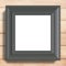 Black photo frame on wood background