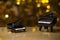 Black piano wooden table gold bokeh reflection