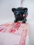 Black piggy bank standing next to Chinese 100 rmb banknotes