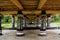 Black pillars with white drawings underneath a house at an old Batak village.