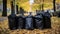 Black plastic bags full of autumn leaves. Large black plastic trash sacks with fallen dried leaves stand on the grass