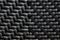Black plastic basketwork pattern process of weaving or sewing pliable materials.