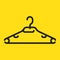 Black plastic clothes hanger, isolated on yellow background