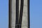 Black plastic hoses with electrical cables on a gray concrete pillar