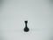 Black plastic rook chess piece isolated on a white background