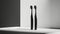 black plastic toothbrushes set against a backdrop of light white and light black, showcasing an asymmetric balance that