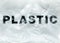 Black Plastic word on transparent white disposable plastic bag. Environment pollution problem concept image with copy space