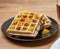 Black plate with homemade waffles, tangerines, chocolate