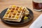 Black plate with homemade waffles, tangerines, chocolate