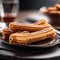 a black plate topped with sugar coated churrons on top of a wooden table