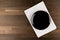 Black Plate on White Tablecloth on wooden table