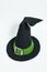 Black pointed Magic witch or wizard hat with green ribbon and silver buckle.  Isolated on a white background.