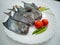 Black Pomfret Decorated with Vegetables and Herbs