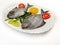 Black Pomfret Decorated with Vegetables and Herbs