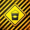 Black Popcorn in cardboard box icon isolated on yellow background. Popcorn bucket box. Warning sign. Vector Illustration