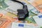 Black power plug on euro banknotes