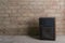 Black powerful speaker standing on the floor against vintage brick wall.Concept of recording or music studio