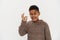 Black preteen boy wearing sweater showing ok gesture and winking