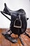 Black professional  leather dressage saddle with stirrups