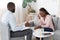 Black Psychologist Talking To Crying Woman During Therapy Session At His Office