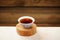 Black puerh tea in white bowl on wooden stand