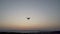Black quadcopter drone landing after filming sea coast