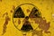 Black radioactive sign over yellow background