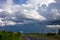 Black rain clouds blew through 4-lane roads with high-voltage electricity poles