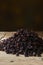 Black raisins over wooden table