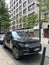 Black Range Rover car stands in front of a high-rise building