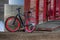 Black and Red Bike leaned against metal post