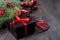 Black and red christmas gift box with red ribbon and fir bran