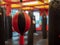 Black and red double end bag hanging in an empty combat sports gym