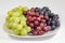 Black, red, green seedless grapes in a deep white bowl