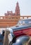 Black and red Mercedes antique car, with Baron Empain Palace in the far end, Cairo, Egypt