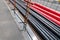 Black and red PVC pipes for underground cables and structures at a construction site on a city street.