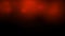 Black-red video background with bursts of orange round boke.