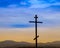 Black religion symbol silhouette Jesus Christ wooden cross on a background with colorful mountain sunset, Easter concept