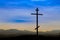 Black religion symbol silhouette Jesus Christ wooden cross on a background with colorful mountain sunset, Easter concept