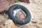 Black rescue buoy on rocks and sands on aboard