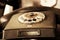 Black retro phone on blurry background. Still life of retro office, telephone on wooden table