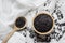 The black rice grains in a wooden cup rested on a white cloth