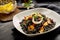 Black Rice and Seafood Dish with Lemon Wedges