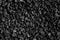 Black road stones gravel texture, rocks for construction, dark background of crushed granite gravel, small rocks, closeup