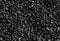 Black road stones gravel texture, rocks for construction, dark background of crushed granite gravel, small rocks, closeup