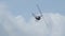 Black Robinson helicopter makes loop and manoeuvre diagonally and fly through sky