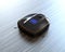 Black robotic vacuum cleaner on laminate flooring