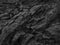 Black rock background. Dark gray stone texture. Black grunge background. Mountain close-up. Distressed backdrop.