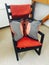 Black rocking chair with orange pillows